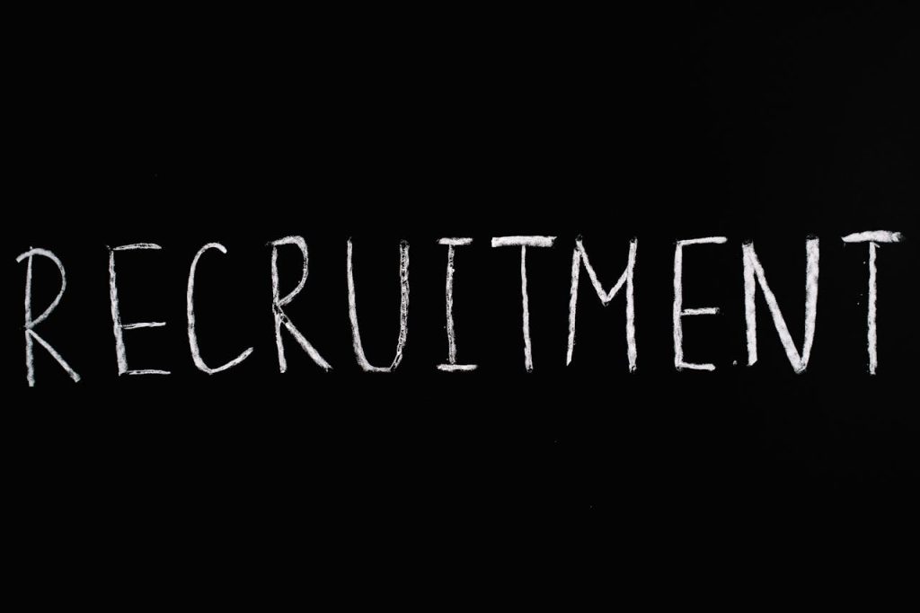 Chalk-written RECRUITMENT on a black chalkboard, ideal for HR and hiring themes.